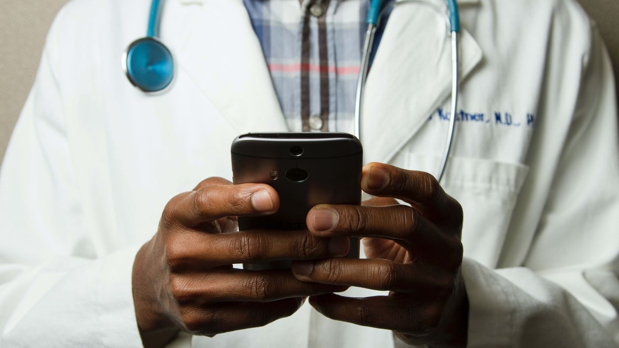 Doctor holding smart phone