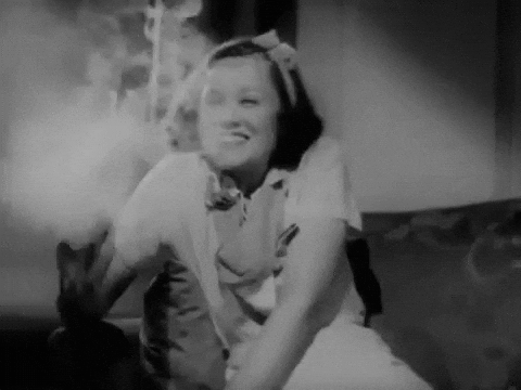 gif of scene from Reefer Madness; woman smoking weed, black and white movie