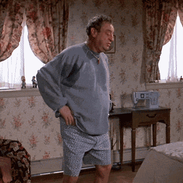 Giphy of Rodney Dangerfield stretching and experiencing back-pain, in an exaggerated/funny manner