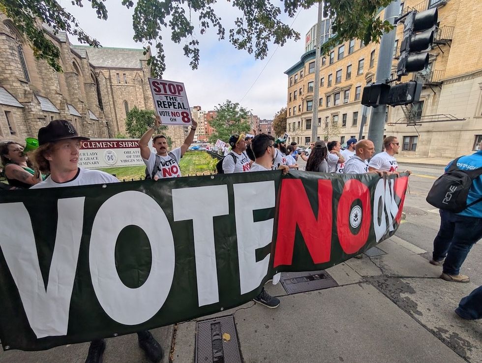 image of Massachusetts demonstrators holding a sign that says "Vote No on 8"