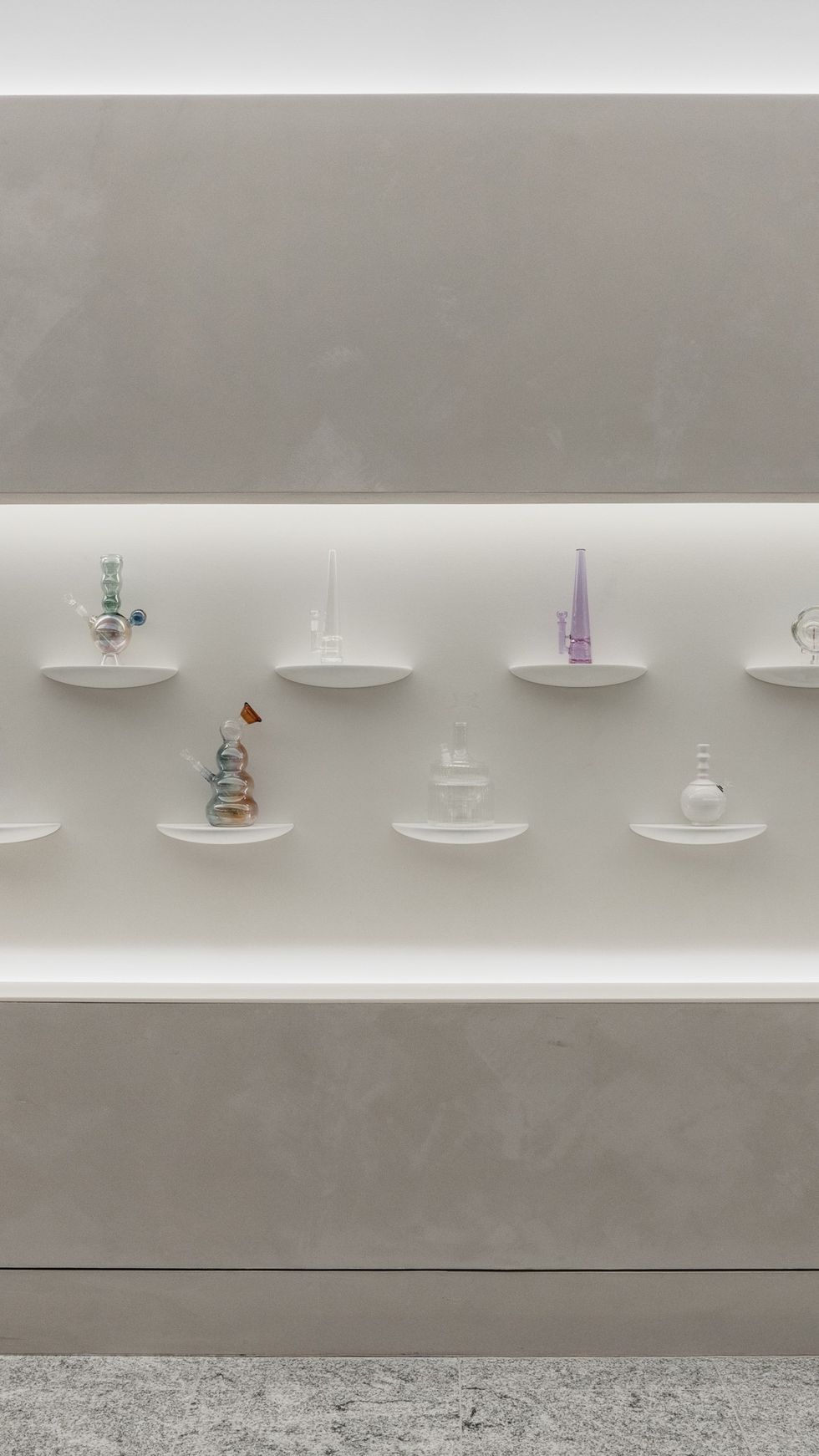 interior image of Travel Agency's new SoHo retail, featuring a wall of glass bongs