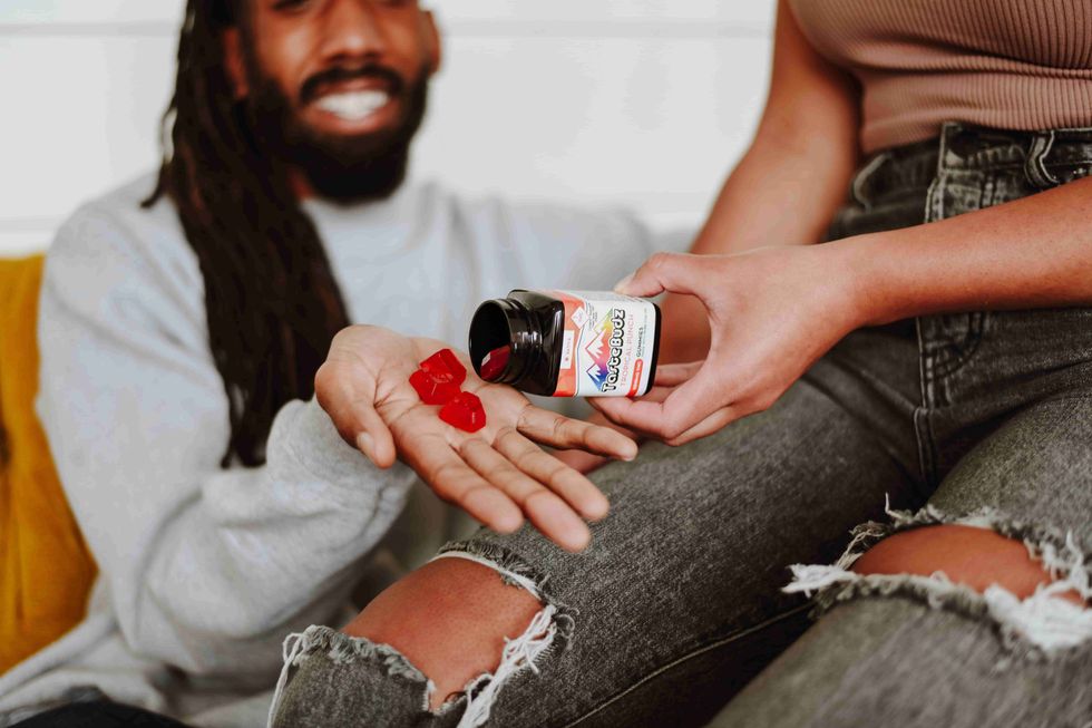 man holding TasteBudz gummy