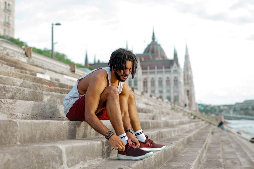 man in exercise clothes tying shoe